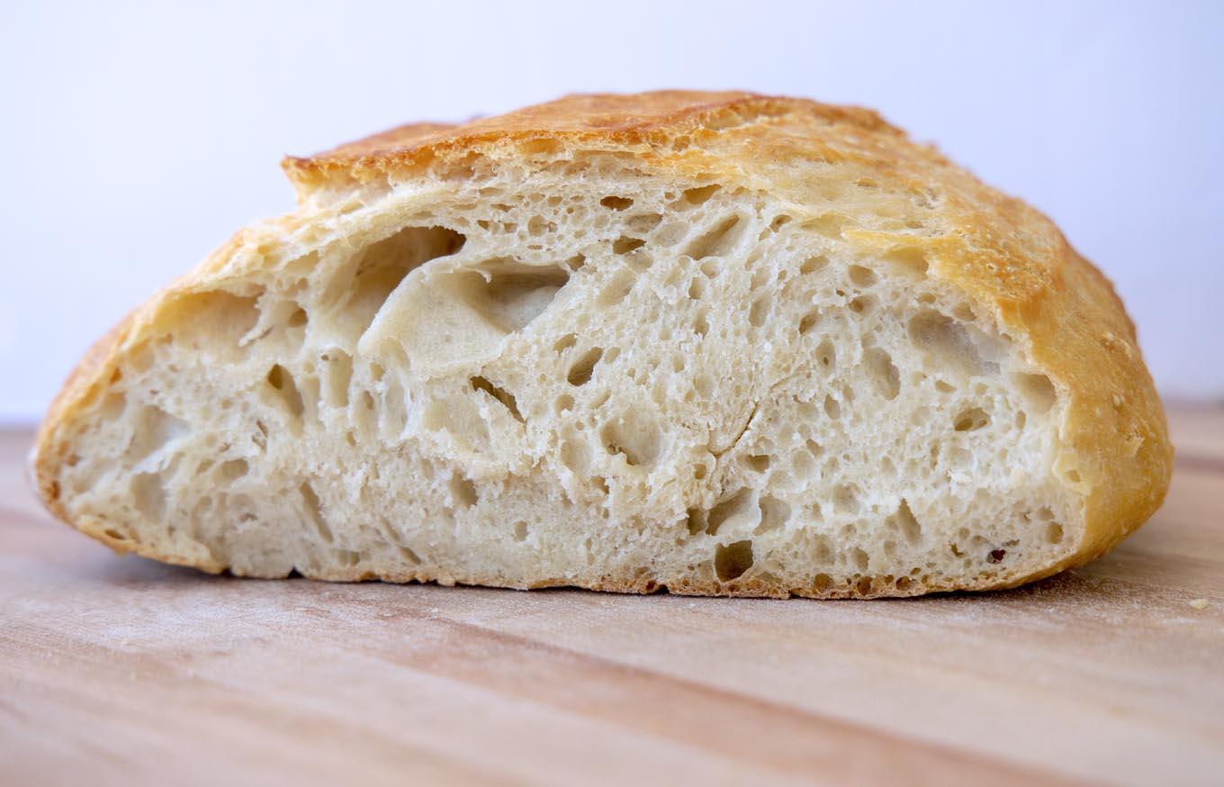 side view of cut loaf of homemade artisan bread