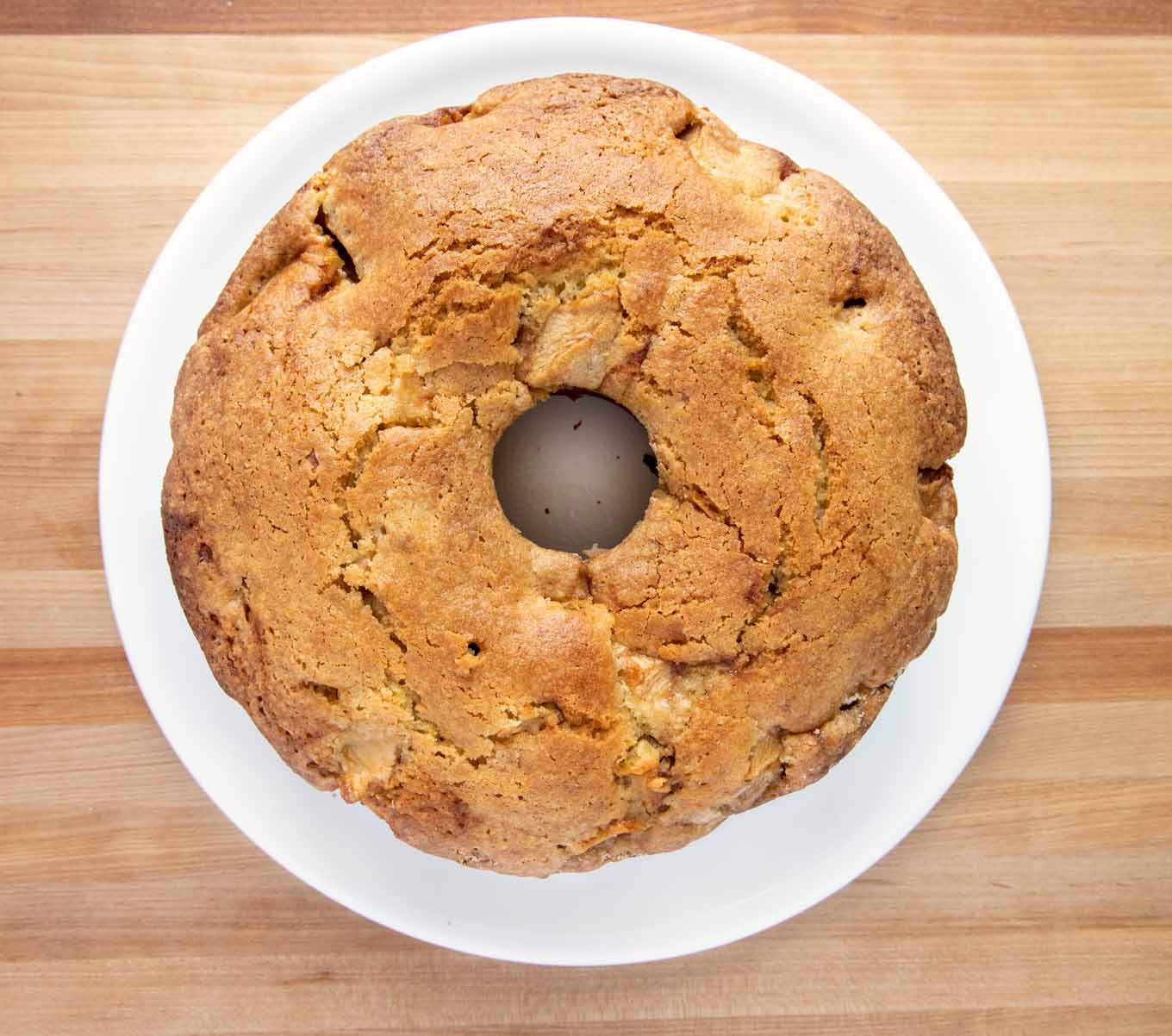 overhead shot of baked Jewish Aopple cake on a white platter