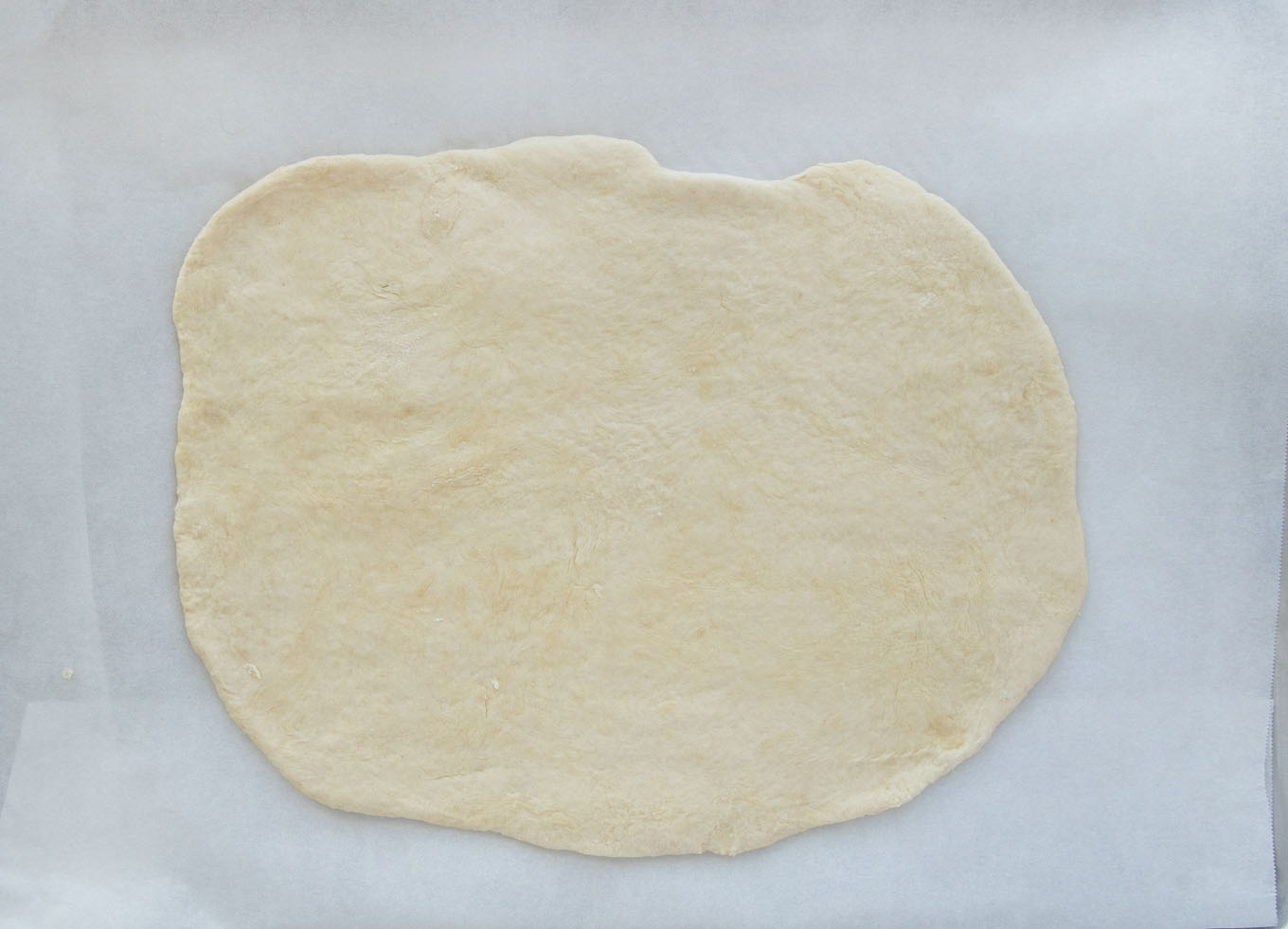 overhead view of rolled out puff pastry sheet