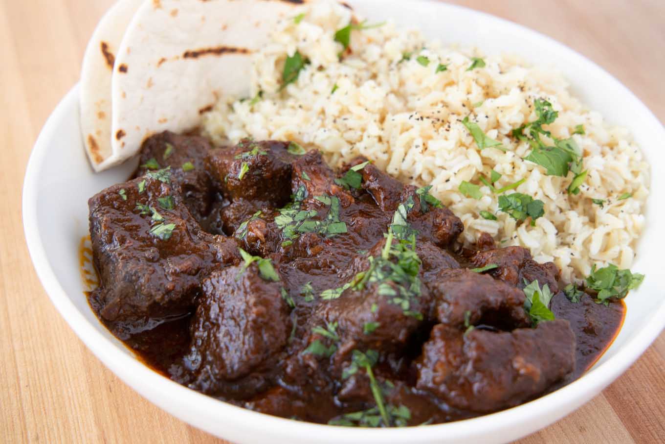 close up of beef Colorado and rice in a white bowl