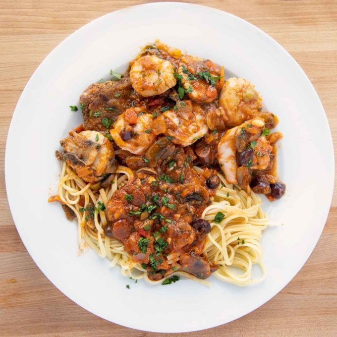 Sicilian style seafood served over a fried eggplant plank and linguine