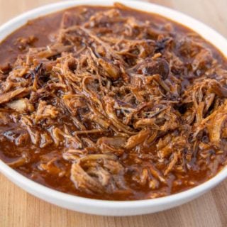 white bowl of pulled pork in barbecue sauce