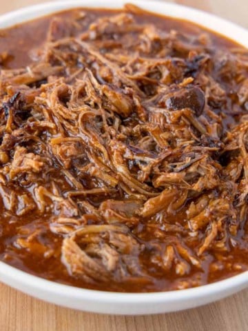 white bowl of pulled pork in barbecue sauce