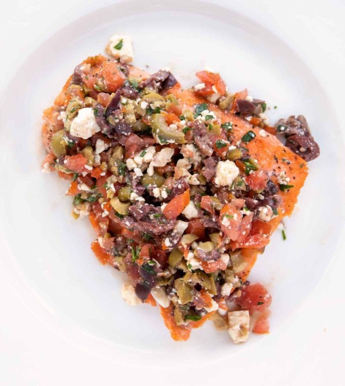 mediterranean style salmon on a white plate