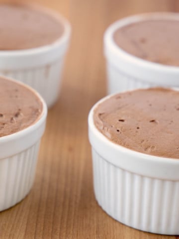 chocolate mousse in four white ramekins