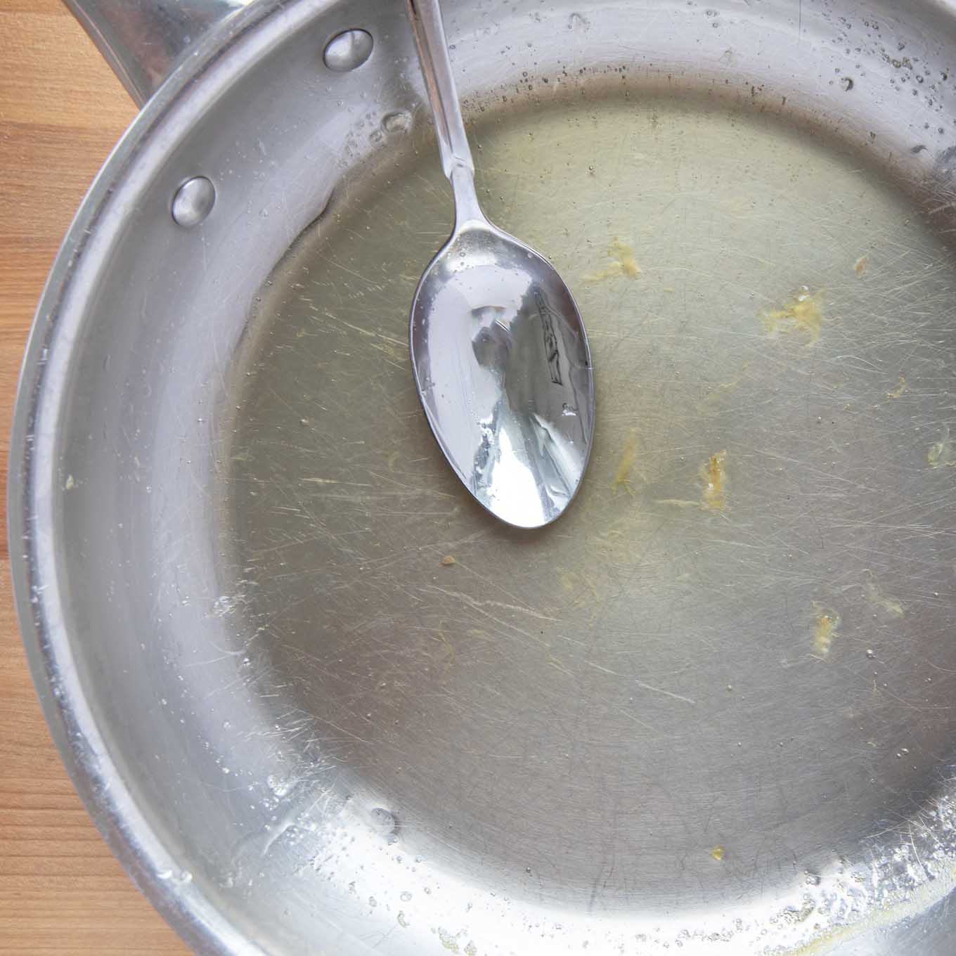lemon syrup and a spoon in a saute pan