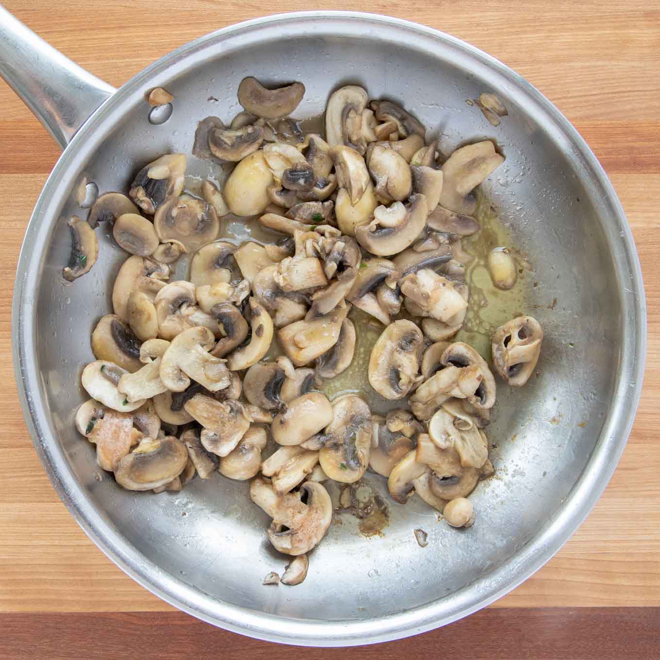 cooked sliced mushrooms in a saute pan