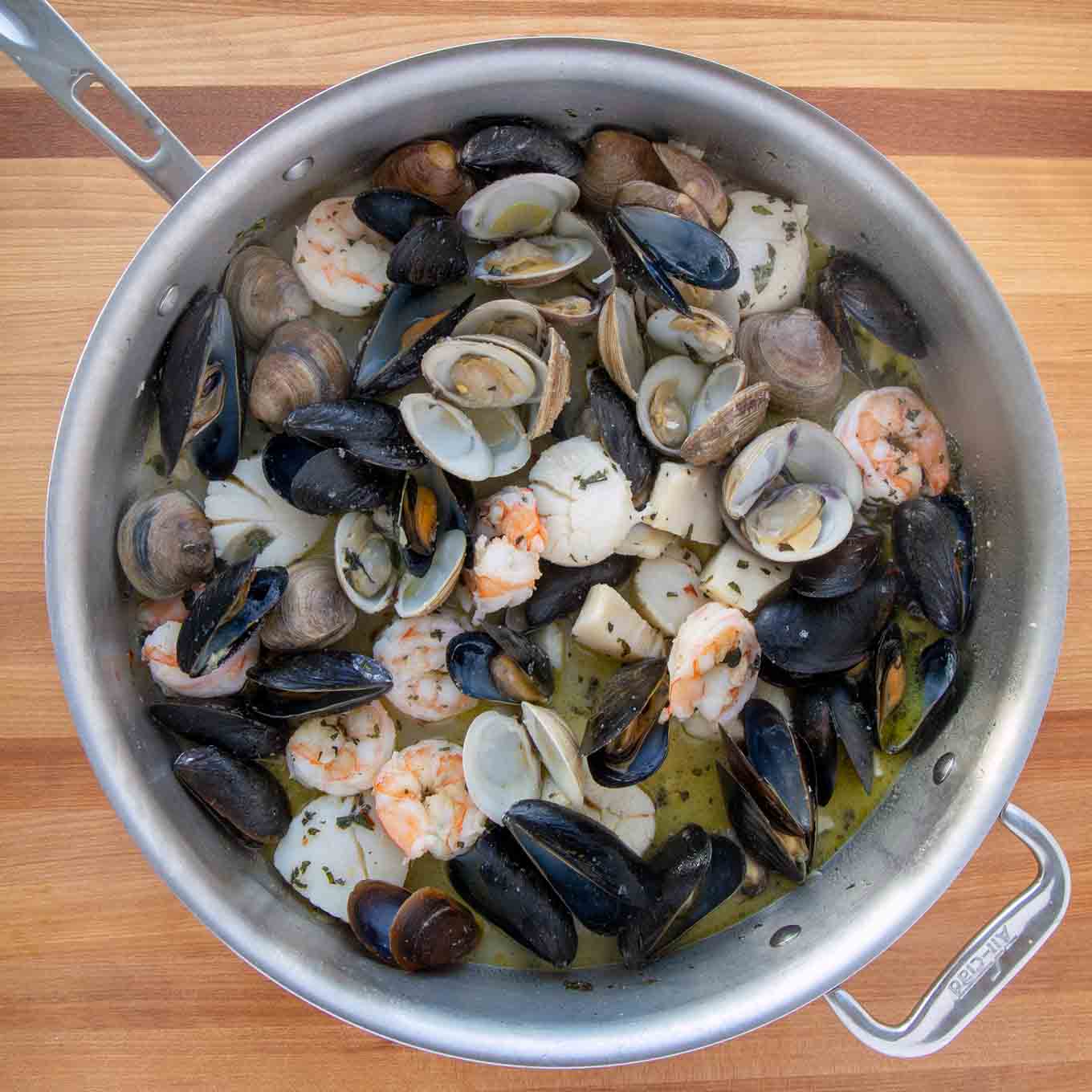 cooked seafood in large saute pan