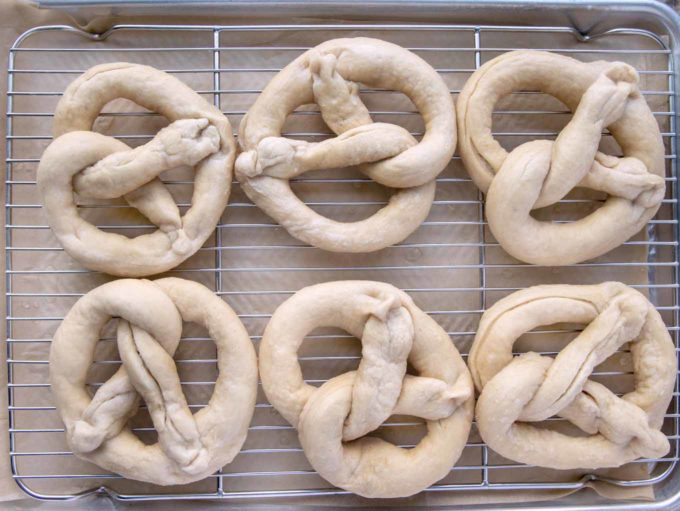 boiled pretzels draining on a wire rack
