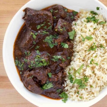 chile colorado and rice in a white bowl