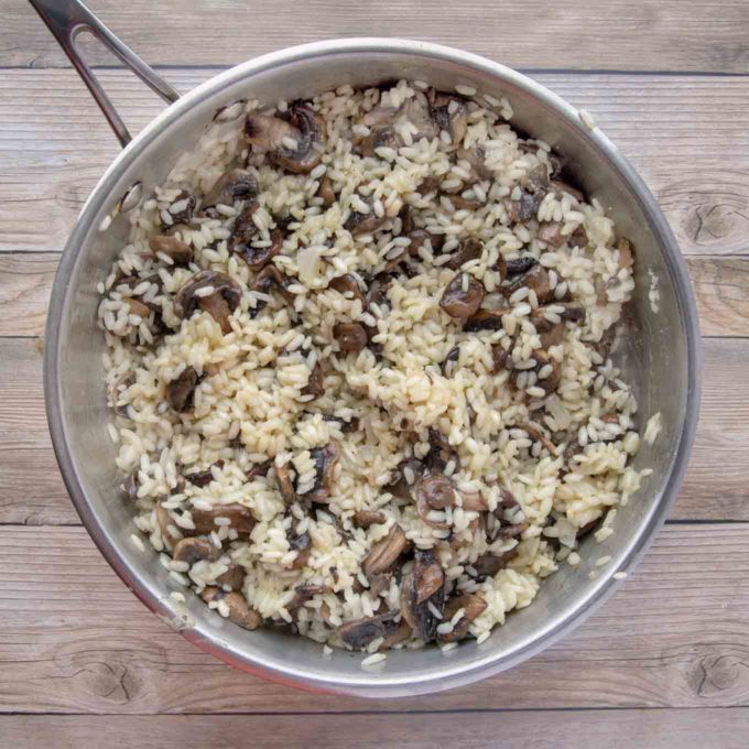 mushrooms added to risotto in large skillet