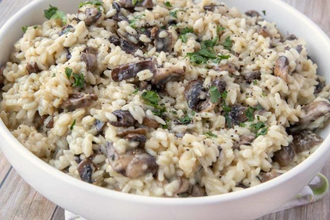 mushroom risotto in a white bowl