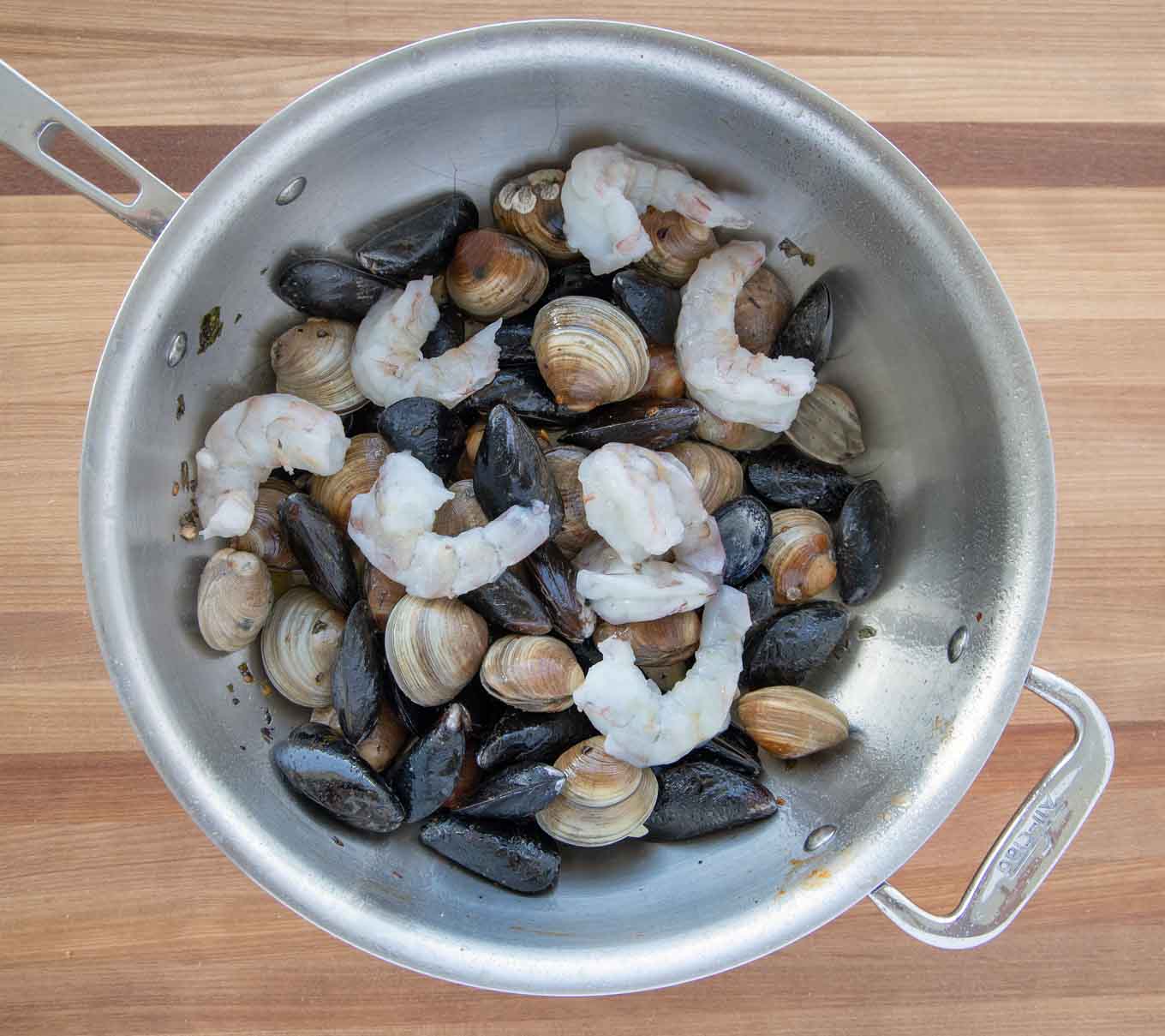 mussels, clams and shrimp added to the large pot
