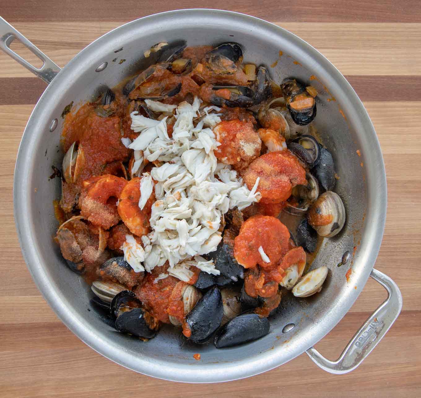 marinara sauce and crabmeat added to the cooked seafood in the pot