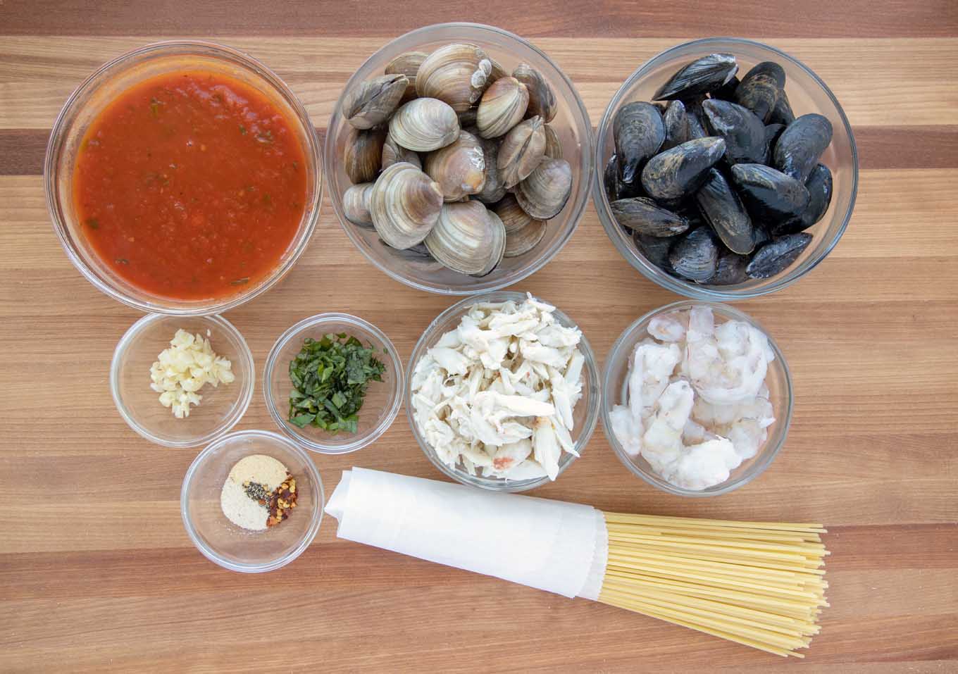 overhead view of ingredients in bowls to make seafood marinara 