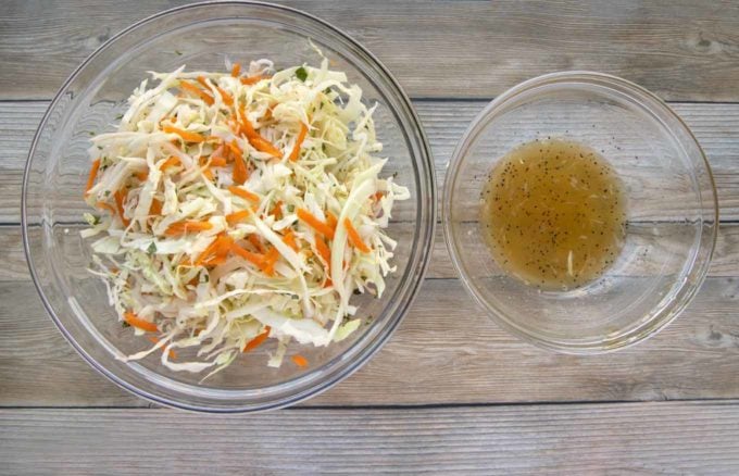 asian slaw mixture and dressing in glass bowls