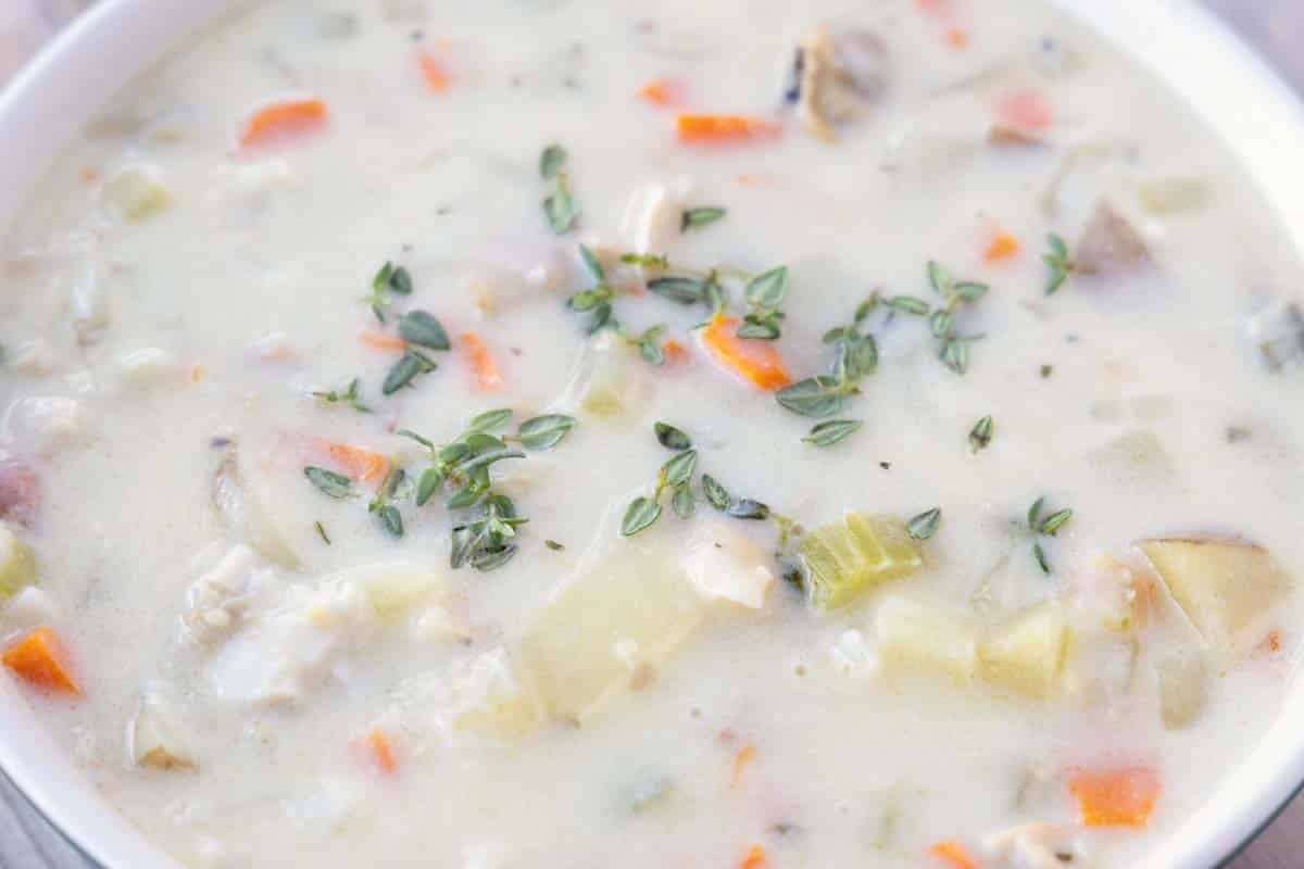 close up of white bowl of New England Clam Chowder