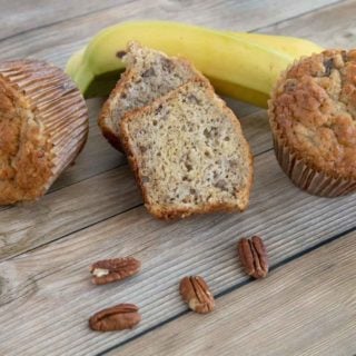 banana pecan muffins with bananas in the background