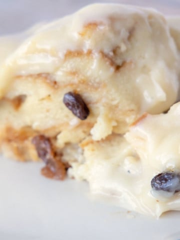 bread pudding with cream cheese frosting on a plate