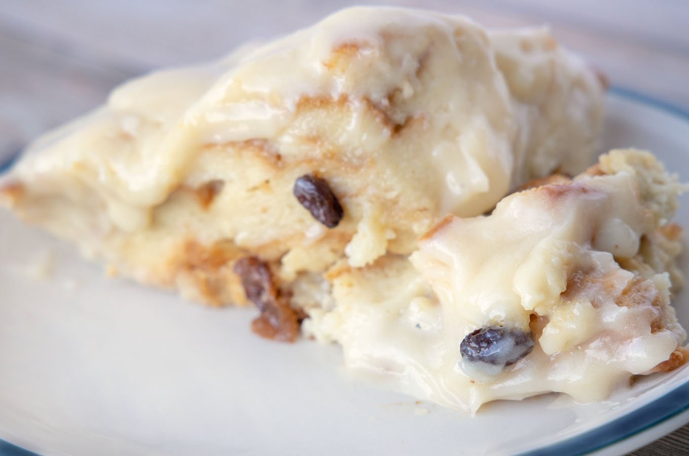 bread pudding with cream cheese frosting on a plate