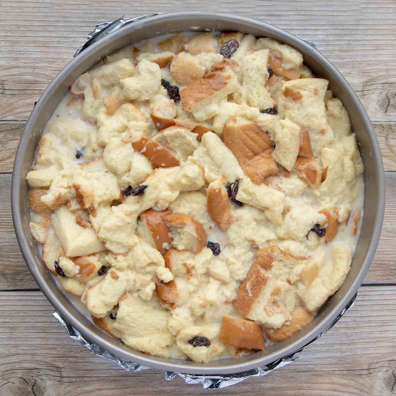 bread  mixed with custard in a springform pan