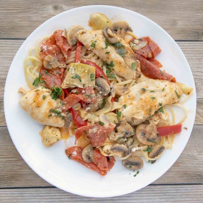 overhead view of chicken pepperoni on a white plate