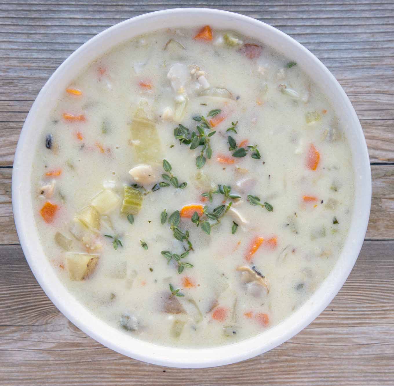 overhead view of New England clam chowder in a white bowl