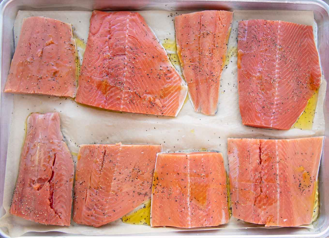 prepared salmon on a sheet pan ready to bake