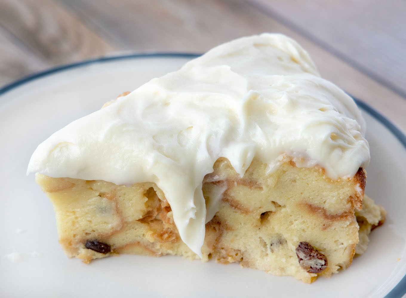 slice of bread pudding topped with cream cheese frosting