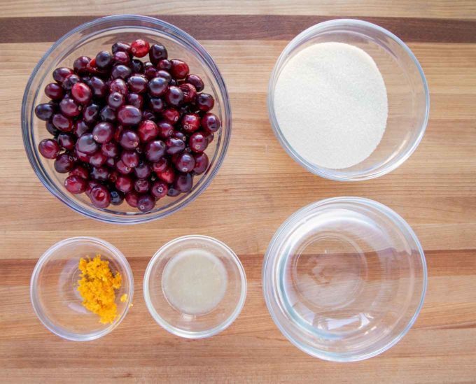 ingredients to make cranberry sauce in glass bowls