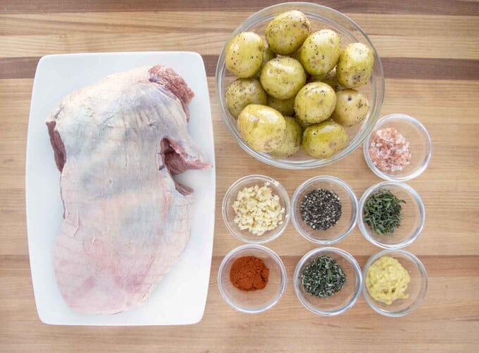 overhead view of ingredients to make oven roasted leg of lamb and potatoes