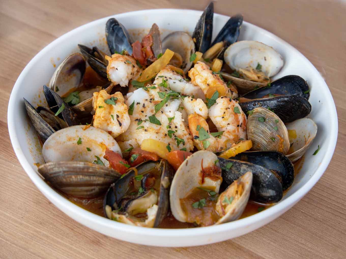 seafood stew in white bowl