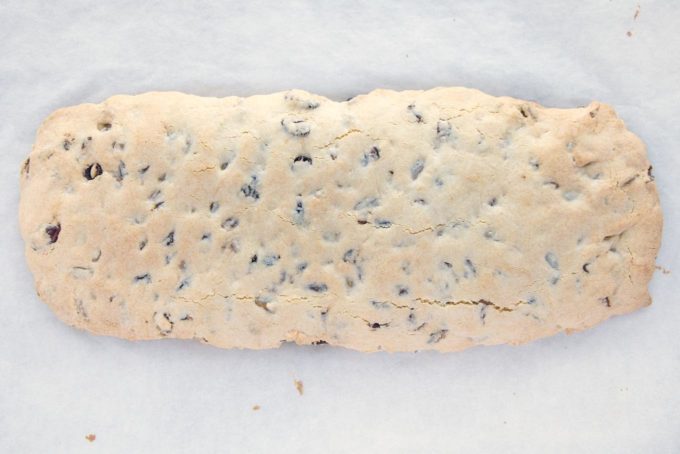 baked biscotti dough log on parchment paper