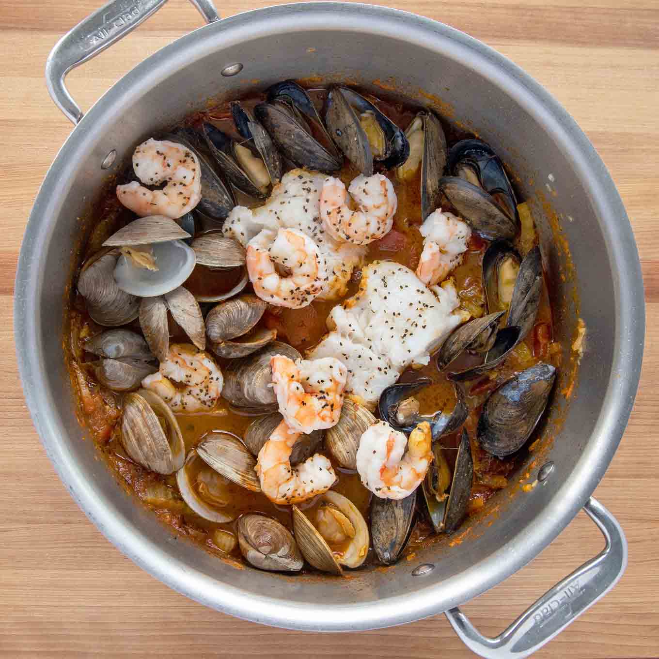 fully cooked seafood stew in large pot 