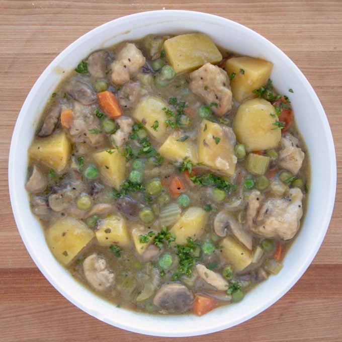 rustic chicken stew in a white bowl