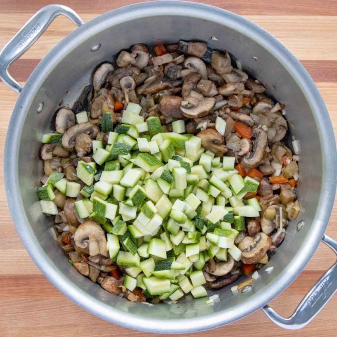 zucchini added to the stock pot