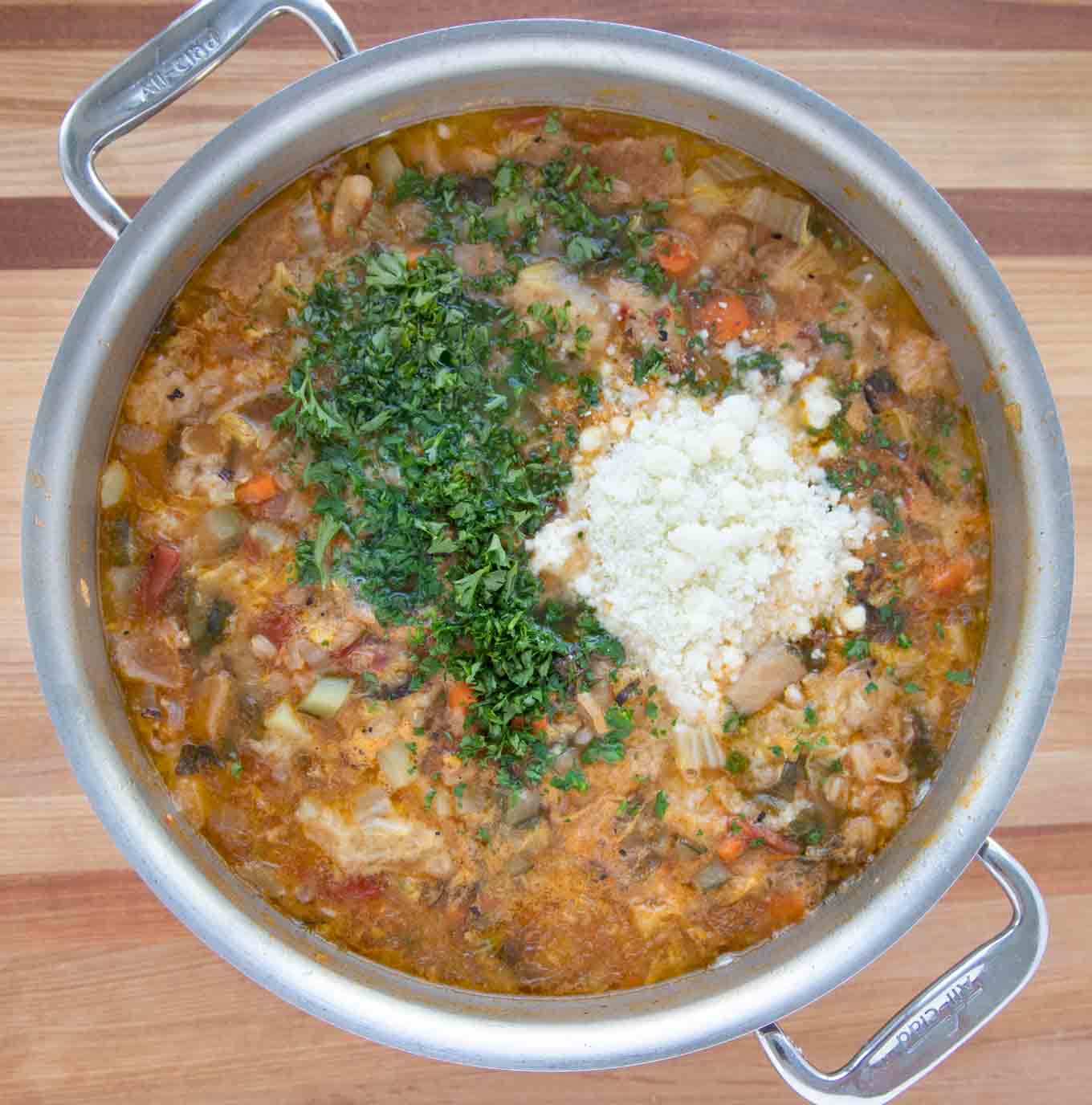 cheese and parsley added to stock pot of Tuscan Bread Soup