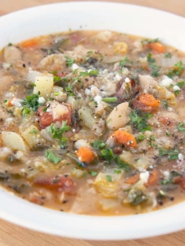 side view of Tuscan bread soup in a white bowl