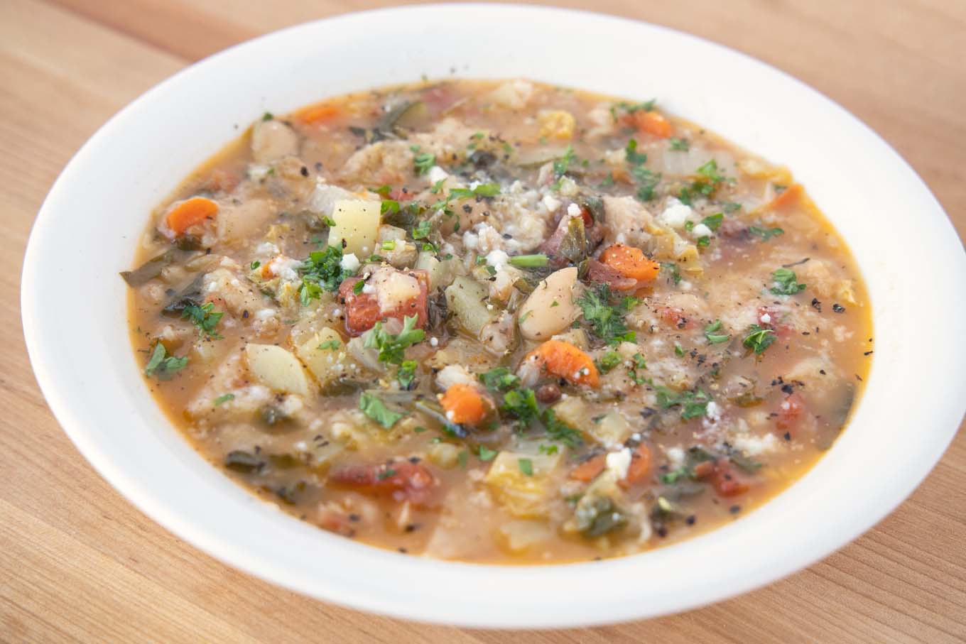 side view of Tuscan bread soup in a white bowl