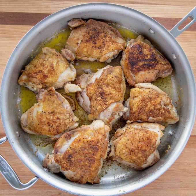 crispy pan seared chicken thighs in a large skillet