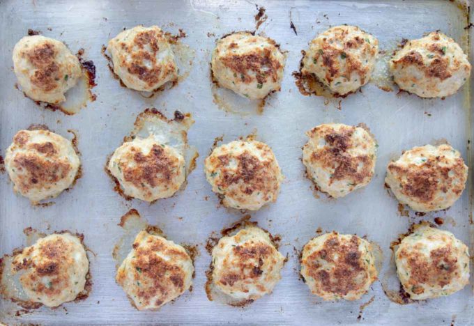 cooked chicken meatballs on a sheet pan