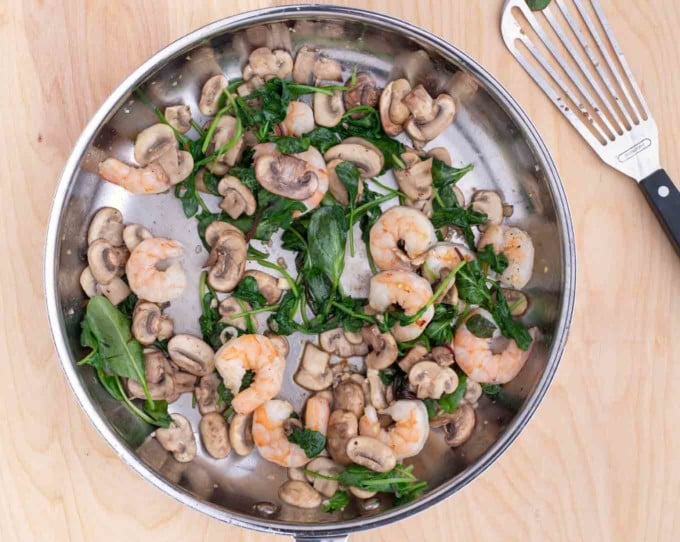 shrimp added to pan with spinach and mushrooms