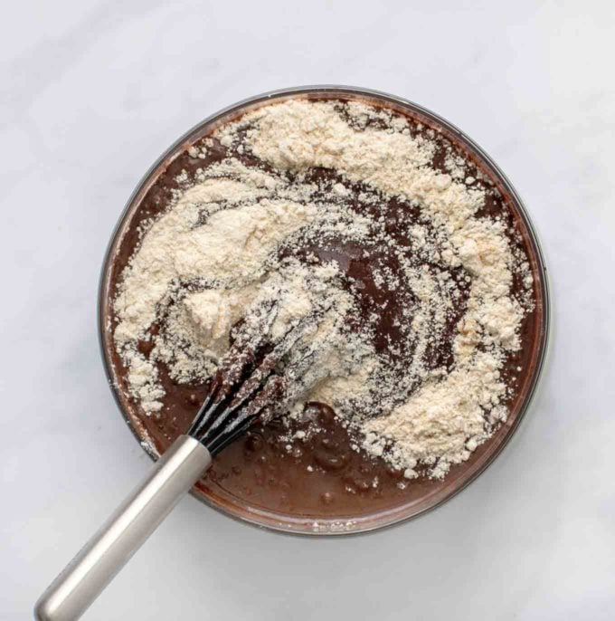 overhead shot of mixing flour mixture into cake batter