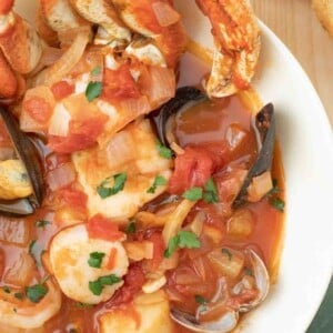 overhead shot of cioppino in a white bowl