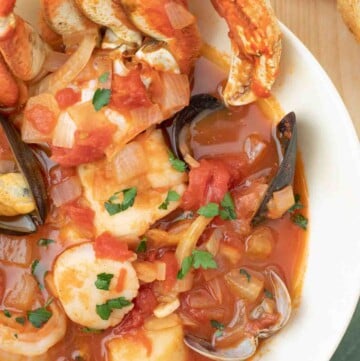 overhead shot of cioppino in a white bowl