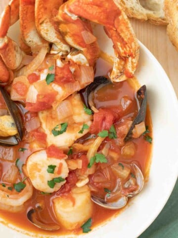 overhead shot of cioppino in a white bowl