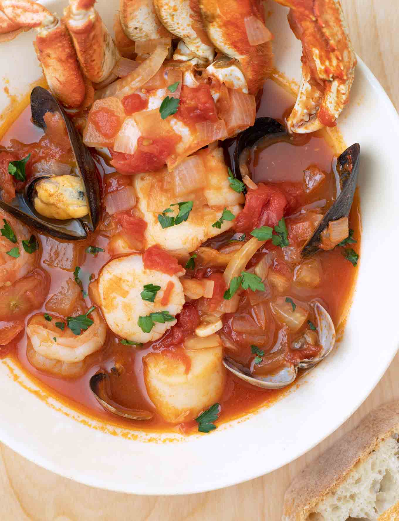 overhead shot of cioppino in a white bowl