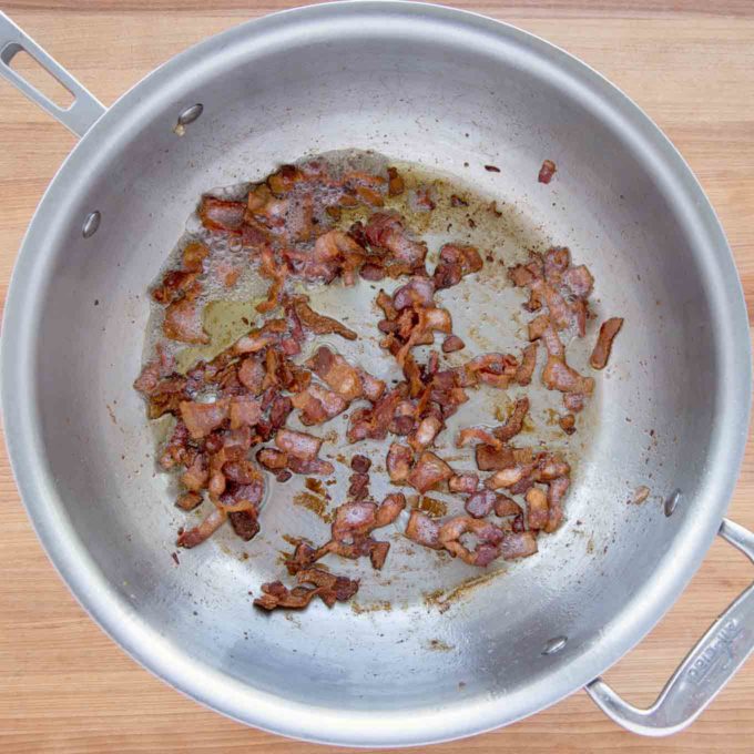 crispy cooked bacon pieces in a large skillet