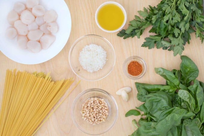overhead view of ingredients to make pan seared scallops and linguine alla pesto
