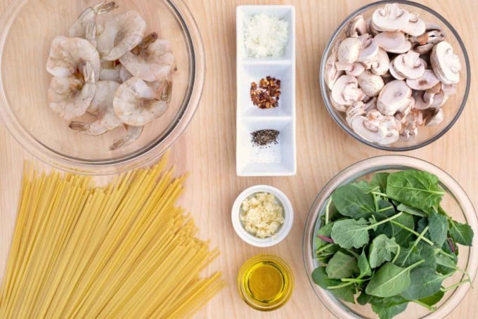 overhead view of ingredients to make garlic shrimp and spinach